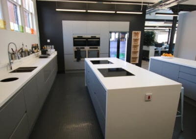 Kitchen work area completely cladded with solid surface Corian� worktops. Bespoke manufacture and fit-out